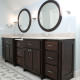 modern bathroom,double vanity,round mirrors,end panel,dark stained cabinets