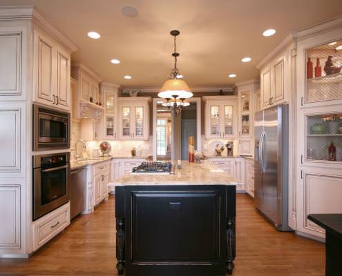 glass doors,black island,french country kitchen,stainless appliances