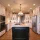 glass doors,black island,french country kitchen,stainless appliances