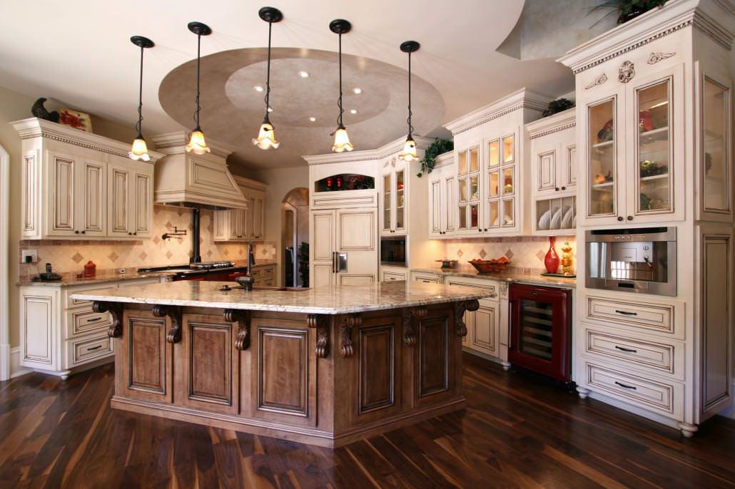 Custom Cabinets by Walker Woodworking. This beautifully styled french country kitchen has many elements of character. The custom hood, egg and dart trim accompanied by the glass front cabinets give this kitchen the feel of warmth and welcome! Photo by Walker Woodworking Staff - All Rights Reserved.