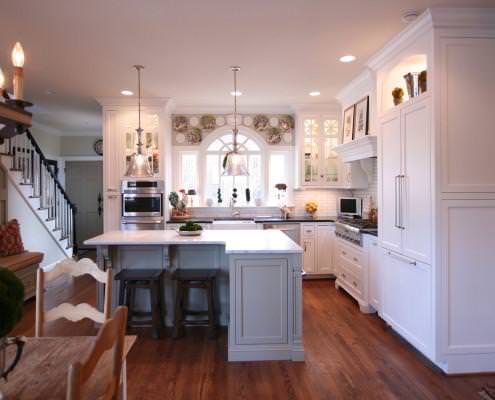 white kitchen,painted cabinets,island,mantle hood,display shelf,glass front cabinets