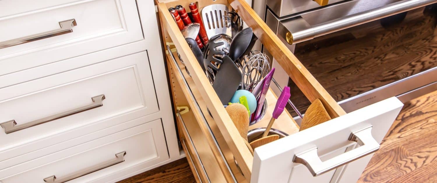 https://walkerwoodworking.com/wp-content/uploads/2023/02/Walker-Woodworking-custom-cabinets-utensil-canister-drawer-Belwith-keeler-hardware-pull-out-kitchen-hardware-1500x630.jpg