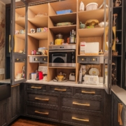 A butler pantry with custom oak cabinetry and a built in small oven and coffee maker