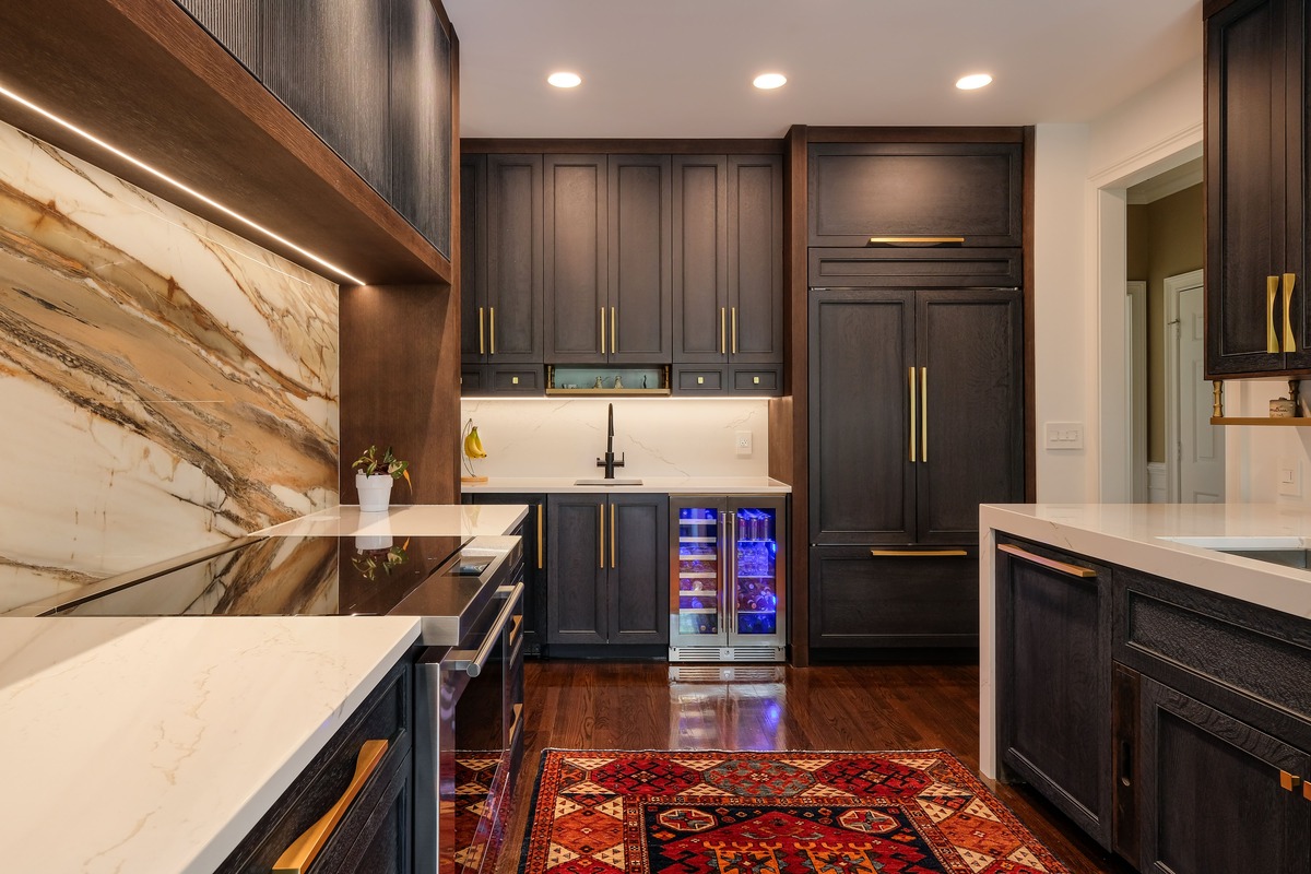 A kitchen with cabinets and paneled appliances with a custom rangehood