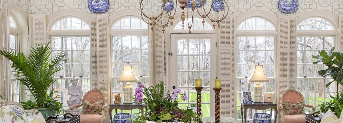 Magnolia Groves vintage sitting room with a lot of windows and plants