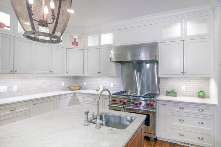 white kitchen and stainless steel hood