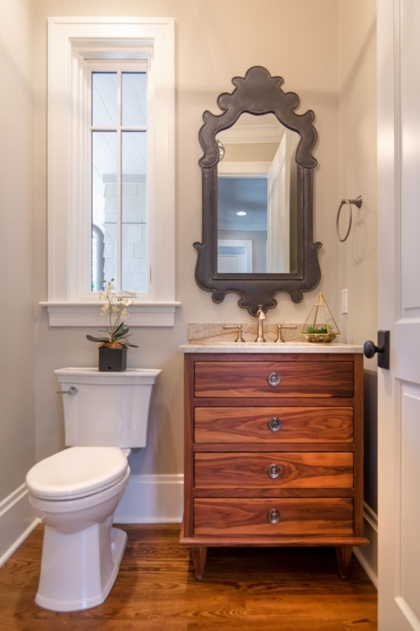 brown bathroom vanity and a small window