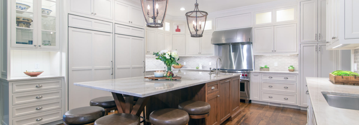 white kitchen with a brown island