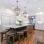 white kitchen with a brown island