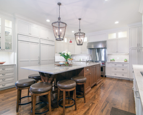 white kitchen with a brown island