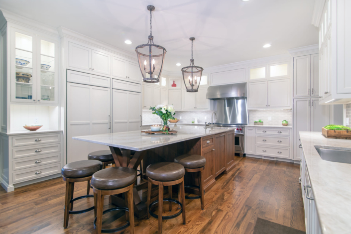 white kitchen with a brown island