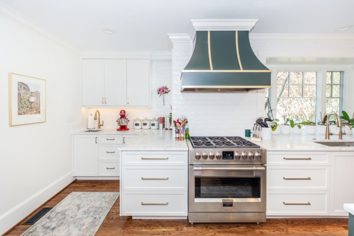 white kitchen with a large blue hood