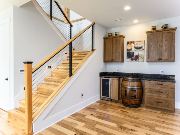 wet bar and a drink fridge in a basement