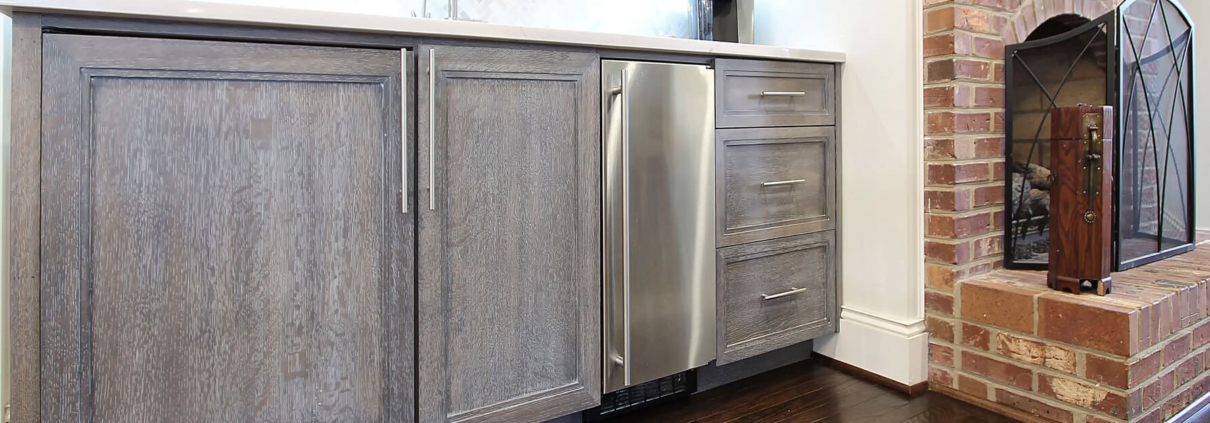 grey beverage center with hardwood floors