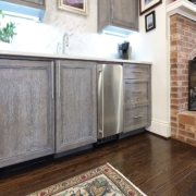 grey beverage center with hardwood floors