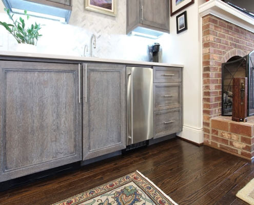 grey beverage center with hardwood floors
