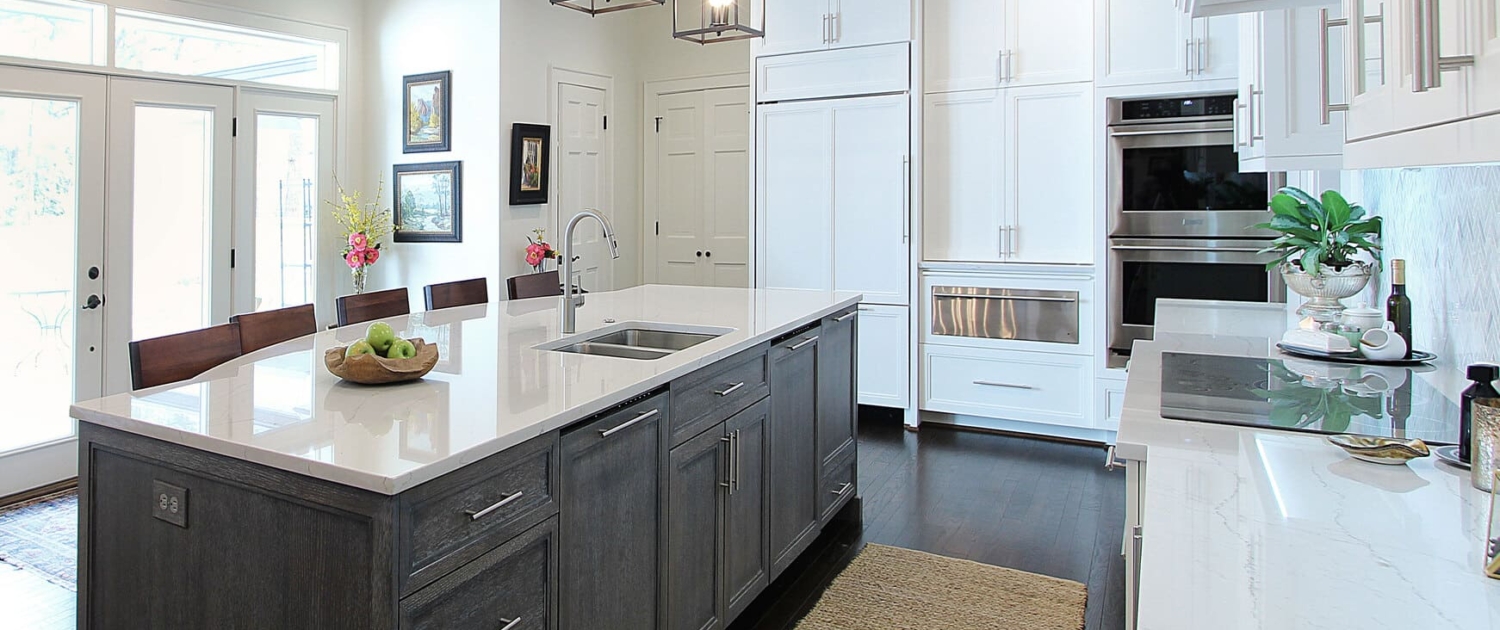 white kitchen with a big grey island