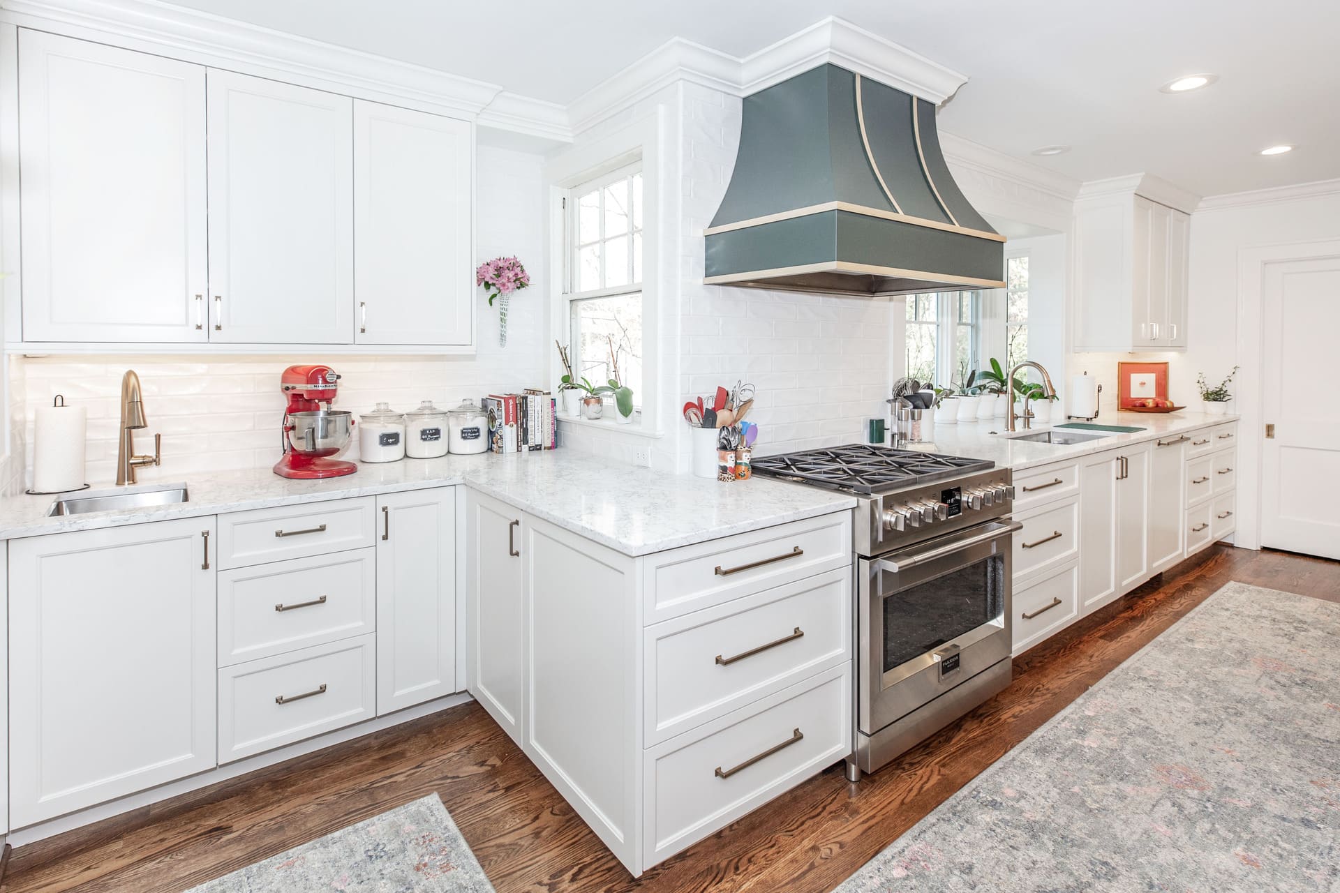 white kitchen with a bakery corner and blue hood