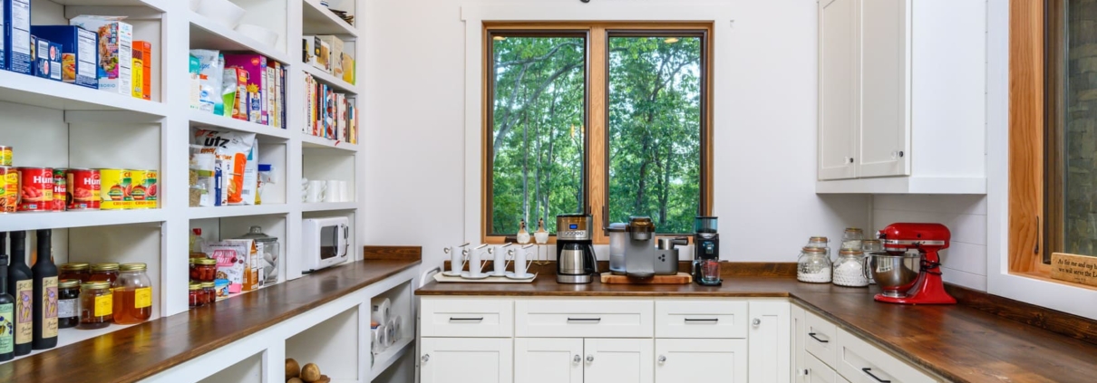 walk in pantry with a coffee bar
