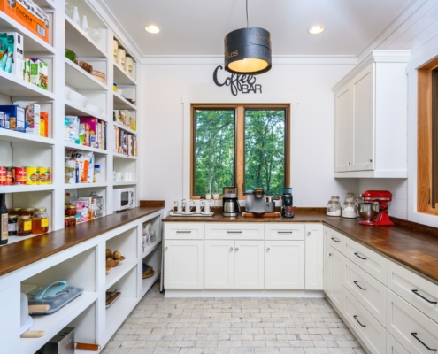 walk in pantry with a coffee bar
