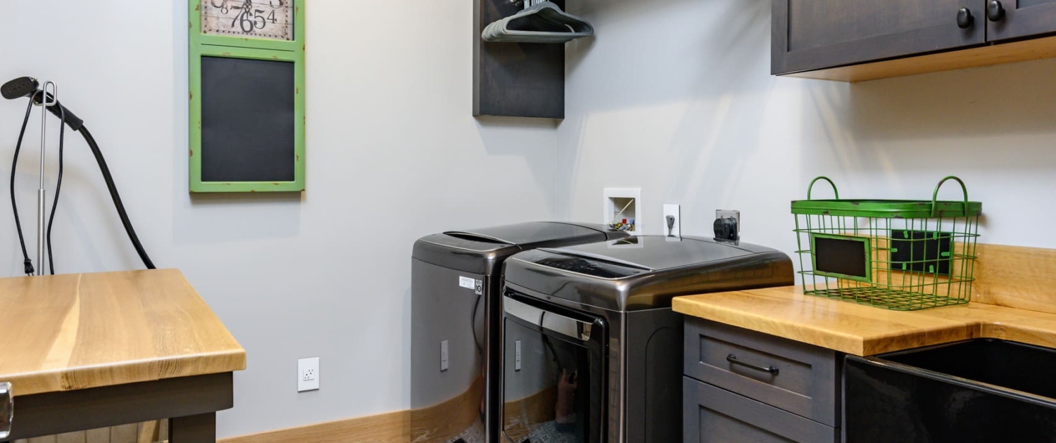 laundry room with hanging storage and a sink