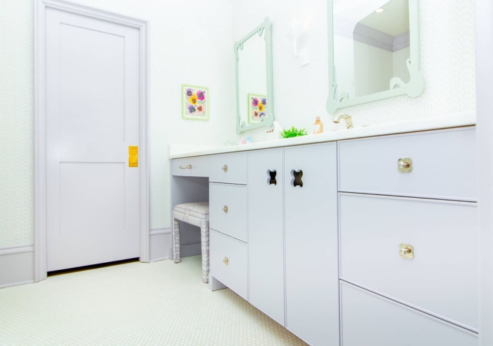 children's bathroom with purple cabinets