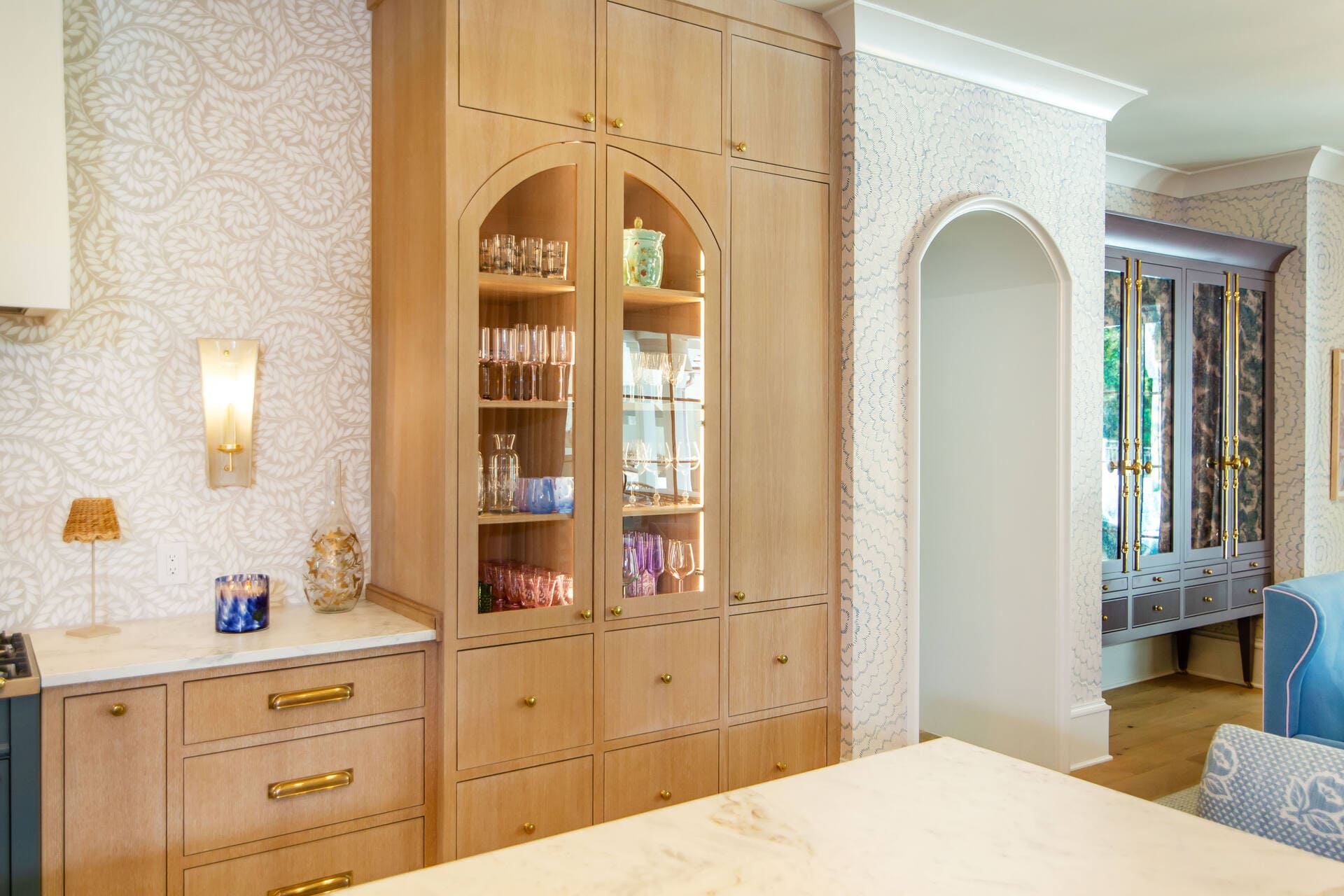 kitchen with glass door storage and wallpaper