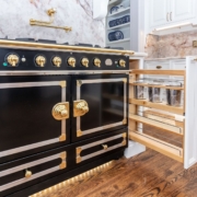 back and gold stove with pullout storage drawers