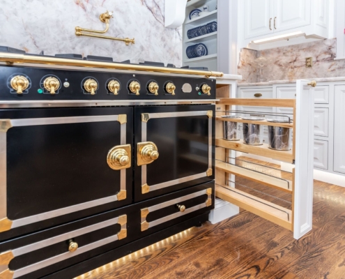 back and gold stove with pullout storage drawers