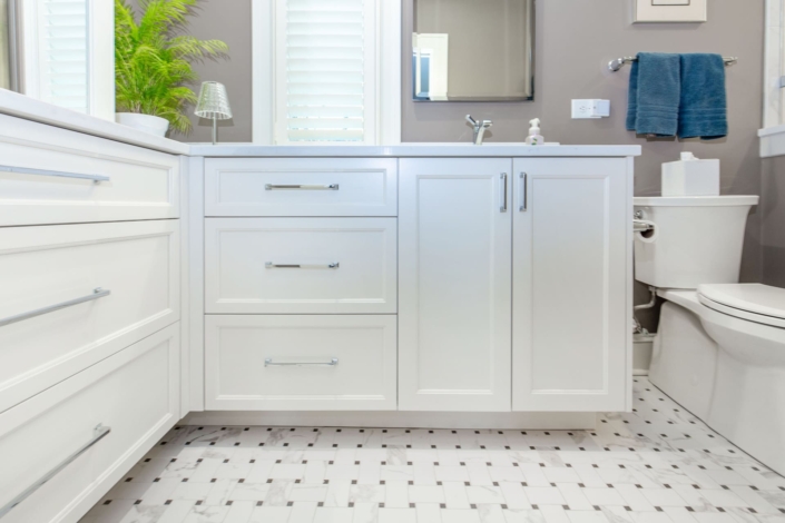 white bathroom with tile flooring