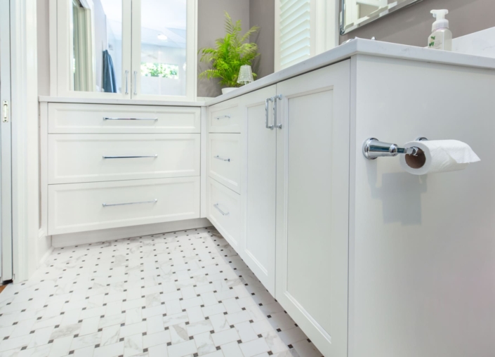 white bathroom with tile flooring