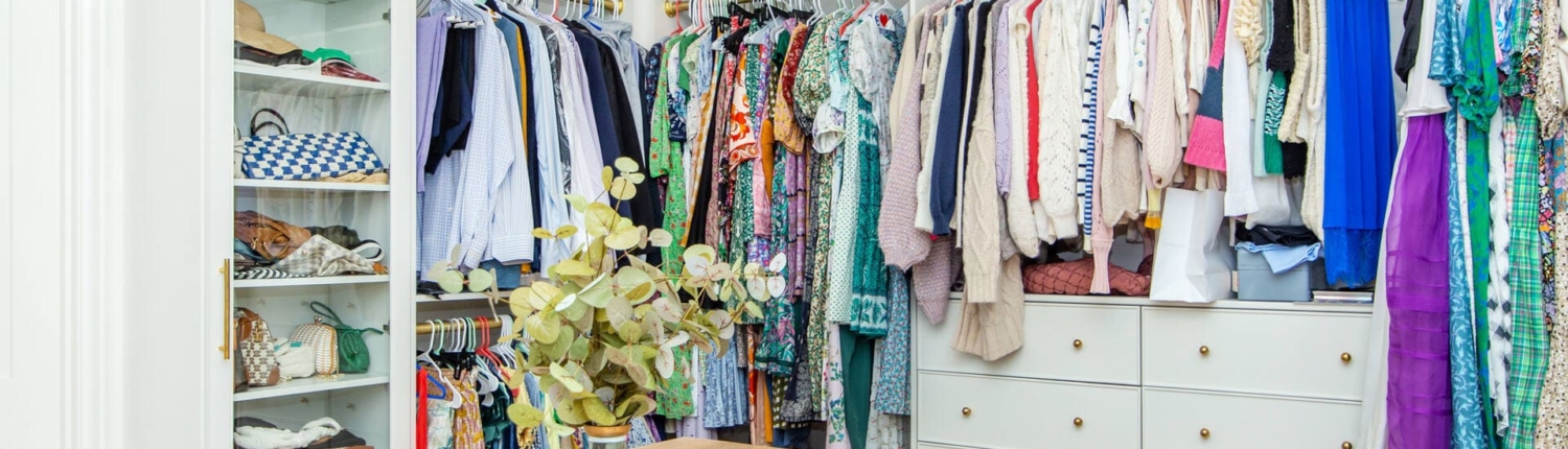white closet cabinets with clothes