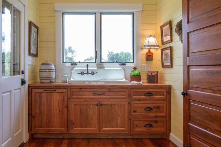 mudroom with a farmhouse sink