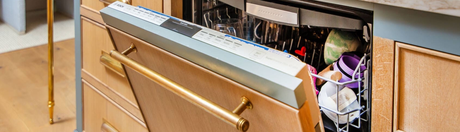 paneled appliance dishwasher with gold hardware
