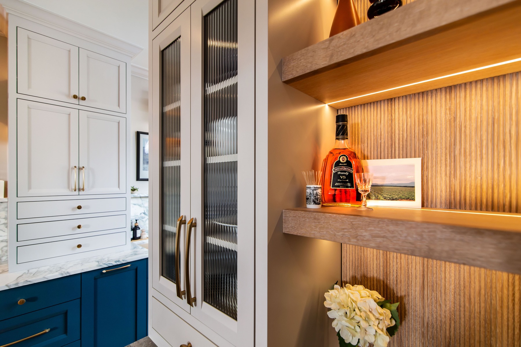 Custom shelving and white cabinets for storage