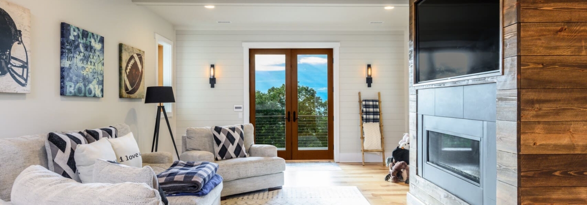 living room with a large entertainment center and glass doors