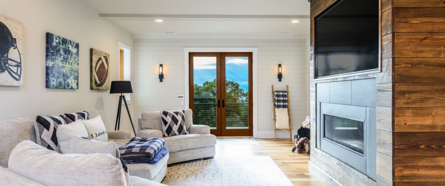 living room with a large entertainment center and glass doors