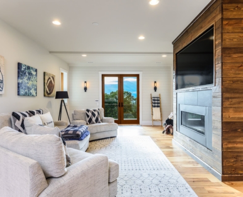 living room with a large entertainment center and glass doors