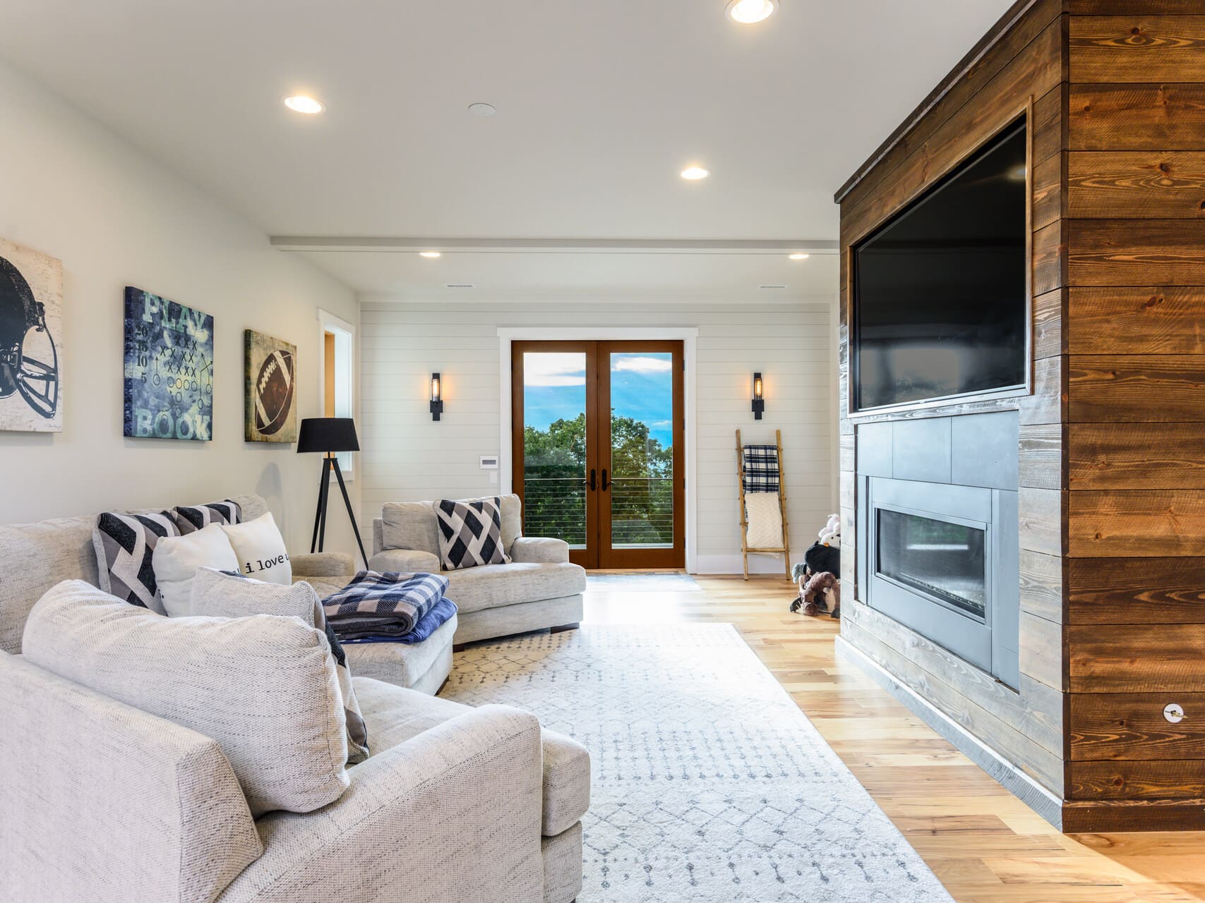 living room with a large entertainment center and glass doors