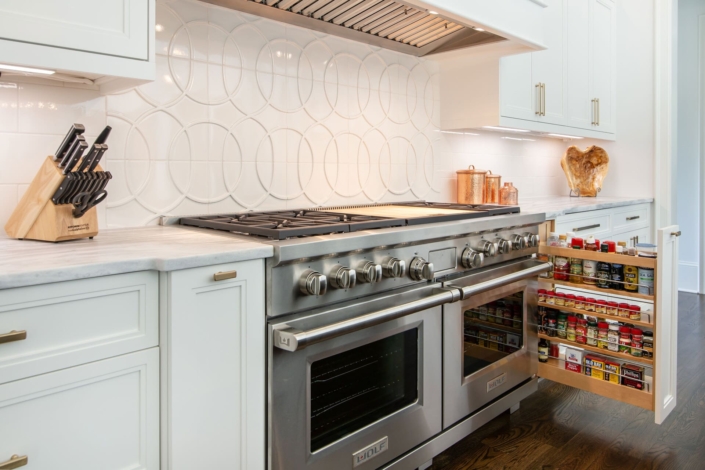 kitchen with a stove and spice drawer