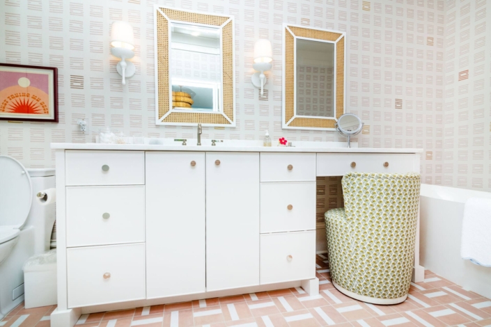bathroom vanity with white and red wallpaper