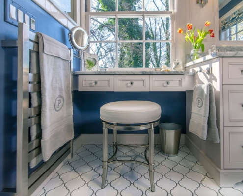 bathroom vanity with seating and a towel warmer