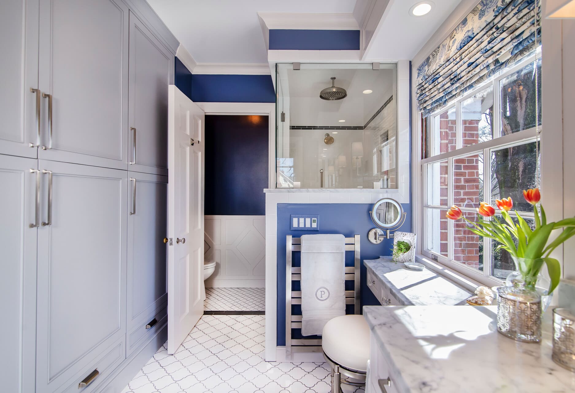 bathroom with storage cabinets and flowers