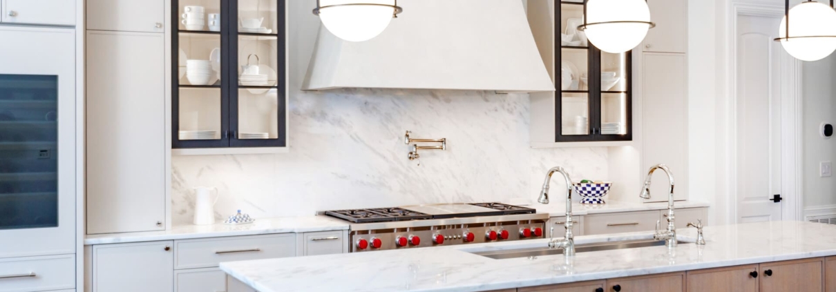 A kitchen with black metal cabinet doors and frameless cabinets with under cabinet lighting