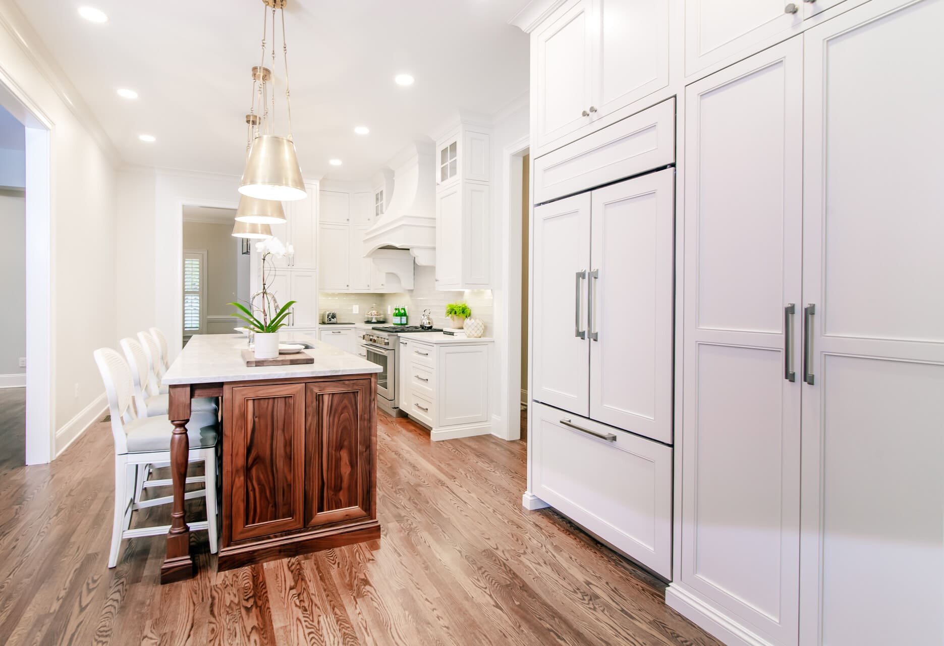 white kitchen with a walnut island