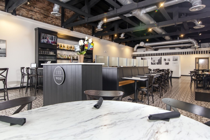 hostess stand, bench, and bar at a restaurant