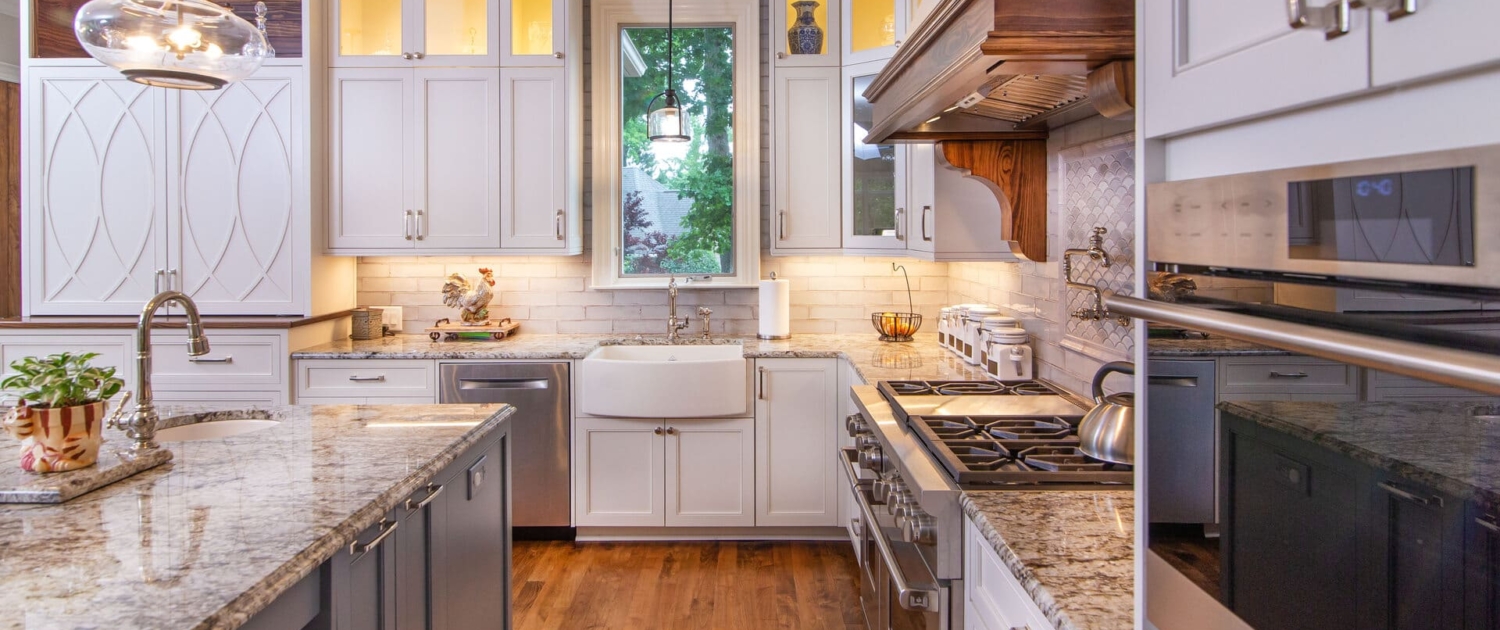 white kitchen with grey island and cabinet lighting