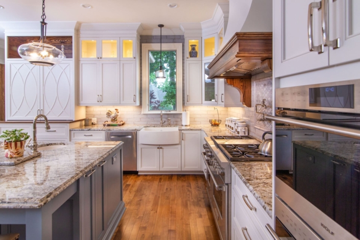 white kitchen with grey island and cabinet lighting
