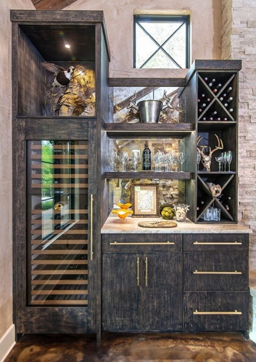 A beverage center with a built in wine cooler and black cabinetry