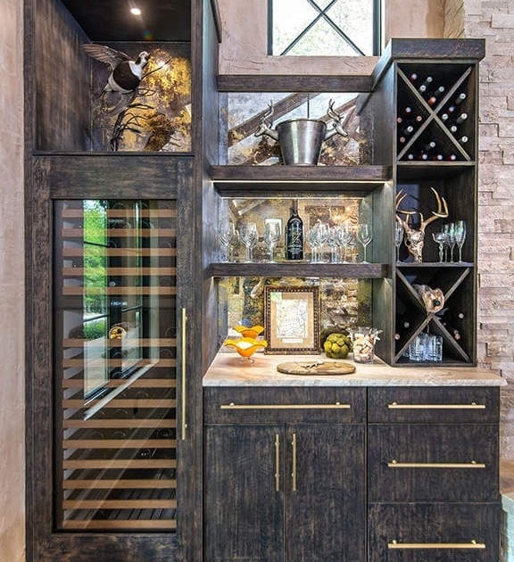 A beverage center with a built in wine cooler and black cabinetry